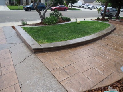 a stamped concrete driveway and mowing strip outside of a home in Rocklin, California