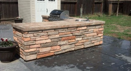 picture of a stacked stone and concrete countertop witha barbecue installed into it in Rocklin, California